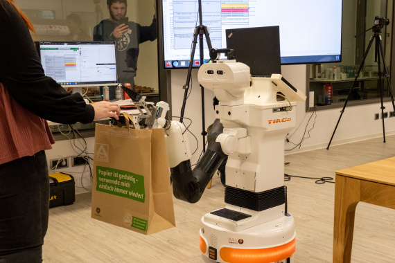 THe TIAGo robot performs the "Carry my Luggage" task